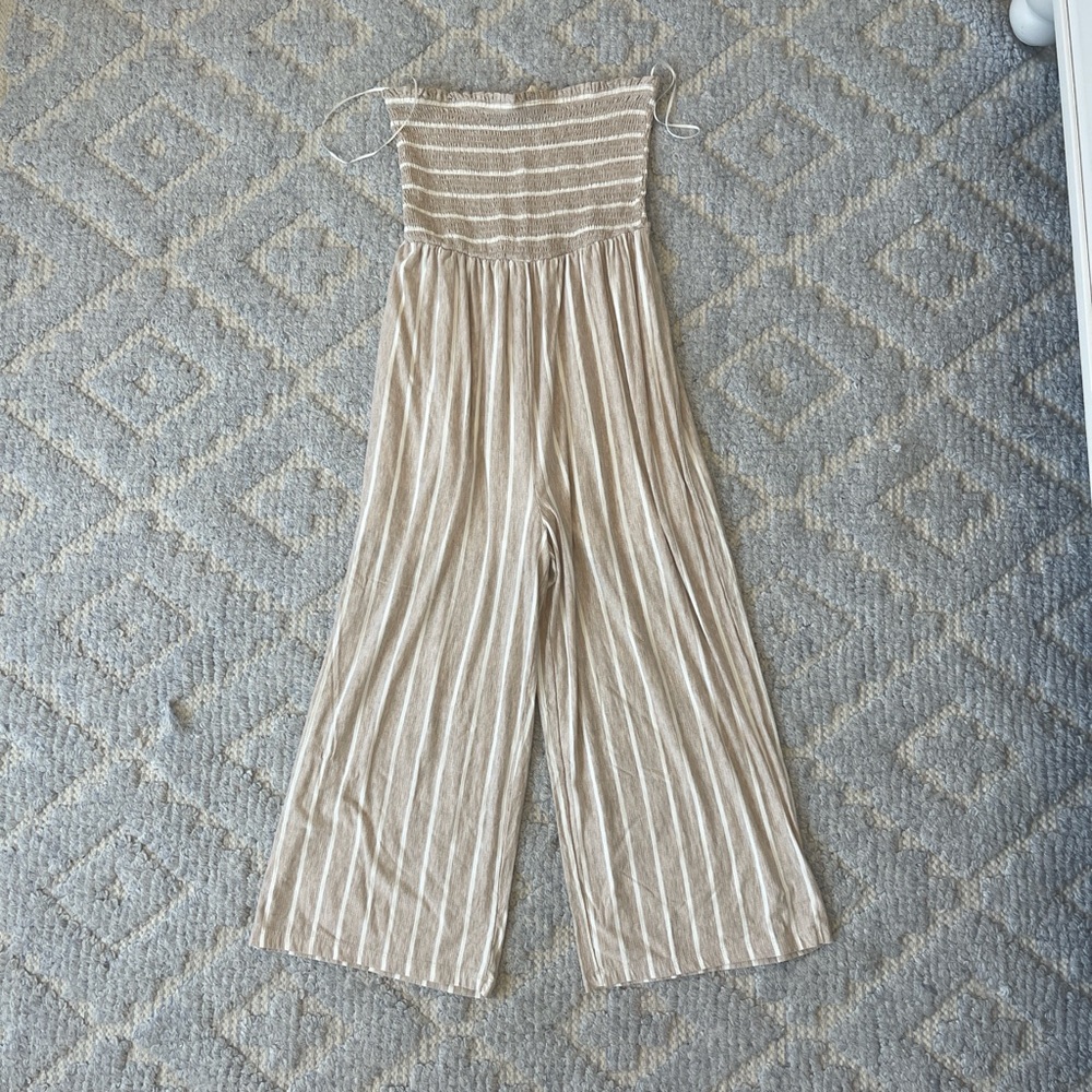 Smocked strapless jumpsuit, beige with white pin stripes. Wide leg pant